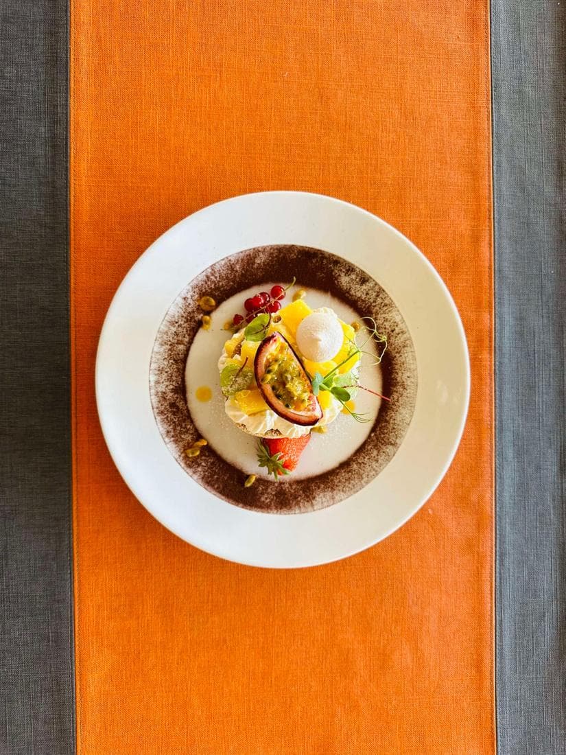 Une assiette du 215 sur le chemin de table orange